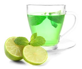 Transparent cup of green tea with mint and lime isolated