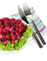 Beet salad on plate on napkin  isolated on white