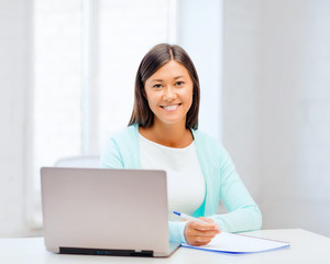 asian businesswoman with laptop and documents
