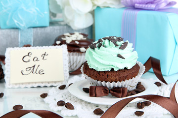 Tasty cupcake with gifts close up
