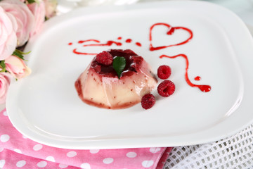 Panna Cotta with raspberry sauce, on wooden background