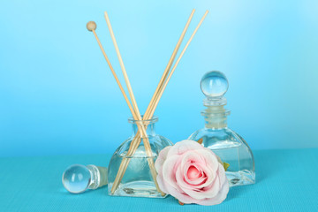 Aromatic sticks for home with floral odor on blue background