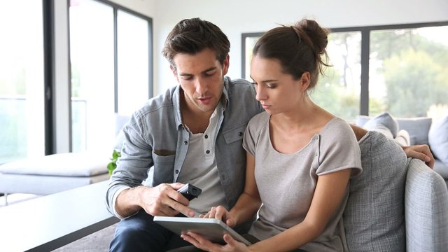 Couple looking for tv program on internet