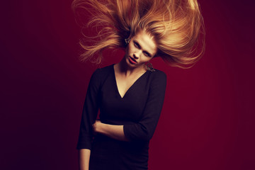 Emotive portrait of a beautiful ginger girl with flying hair