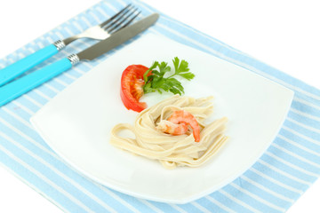 Pasta with shrimps on white plate, isolated on white