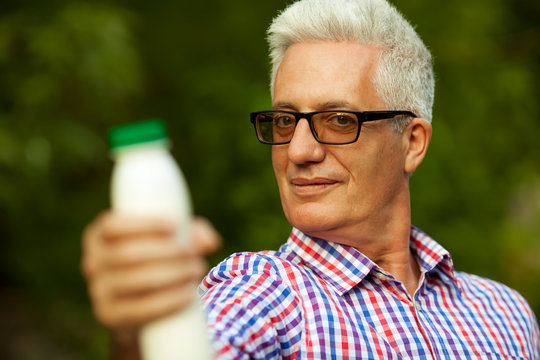 Healthy Food Concept. Mature (old) Man With Milk Product