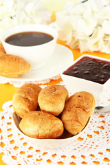 Tasty croissants and cup of coffee on table close-up