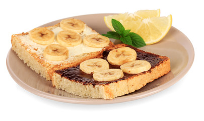 Delicious toast with bananas on plate isolated on white