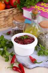 Raw liver in bowl with spices and condiments