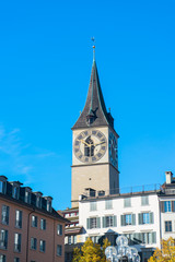 Fototapeta na wymiar Clock tower over the buildings in Zurich, Switzerland