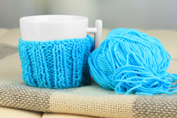 Cup with knitted thing on it close up