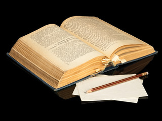 The ancient book and pencil