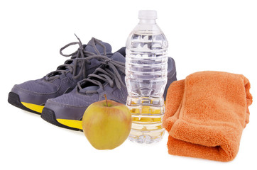 Collection of fitness essentials including running shoes, a water bottle, a sports towel, and an apple. Perfect for illustrating a healthy lifestyle, workout preparation, and gym motivation themes.