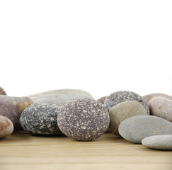 Fototapeta na wymiar pile of stones on wooden board
