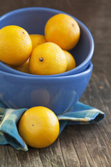 Fresh ripe orange tangerines ib blue bowl.