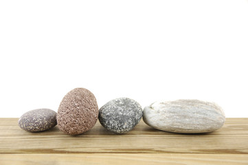 Fototapeta na wymiar Set of close-up of colored stones on a wood board