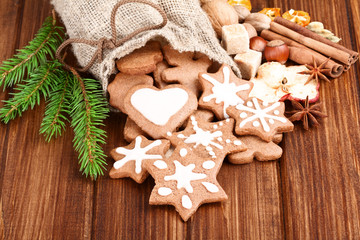 Christmas homemade gingerbread cookies and spice over  wooden bo