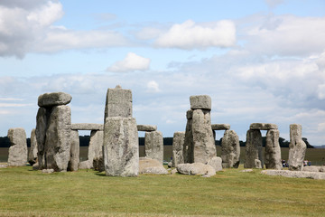 Stonehenge historic site on green grass under blue sky. Stonehen