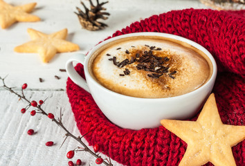 Winter cappuccino coffee in white cup with christmas cookies