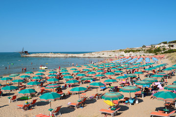 View of beach with umbrellas at beach near Vieste, Apulia,Italy