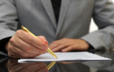 businessman is fulfilling and signing contract