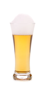 Full glass of beer with foam.