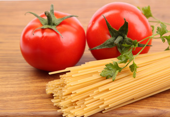 Spaghetti and tomatoes on board.