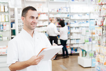 Pharmacist taking notes in a notebook