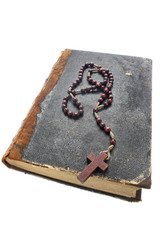 Wooden rosary on old book