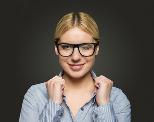attractive businesswoman with glasses on dark background