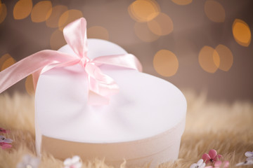Heart gift box on defocused lights background