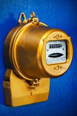 object on blue - Golden retro electric meter