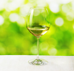 Glass of wine on nature background