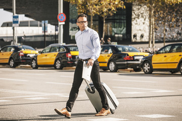 Businessman crossing the street with bag to the convention.