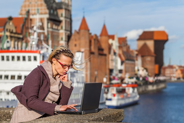 Woman with laptop on the bridge