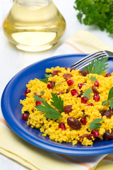 couscous with curry, dried cranberries and herbs, vertical