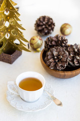 Composition with cup of tea, bumps and christmas tree