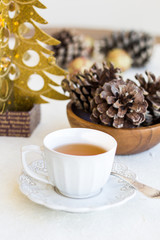 Obraz na płótnie Canvas Composition with cup of tea, bumps and christmas tree