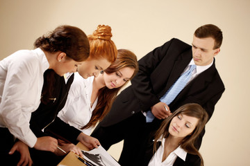 Fototapeta premium Young business people analyzing chart