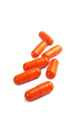 Orange pill capsules isolated on white background