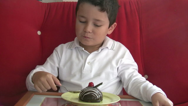 child eating cake and smiling to camera