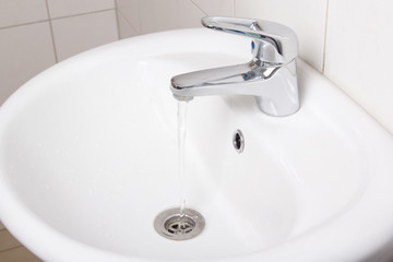 Bathroom interior with white sink and faucet