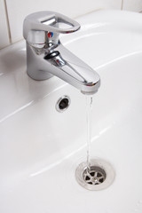 Fototapeta premium Bathroom interior with white sink and faucet