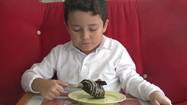 child eating cake and smiling to camera