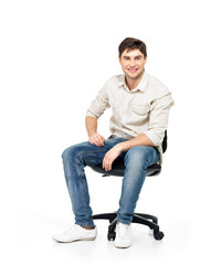 Portrait of smiling happy man sits on office chair