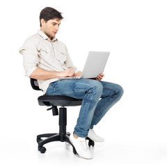 man working on laptop sits on the chair