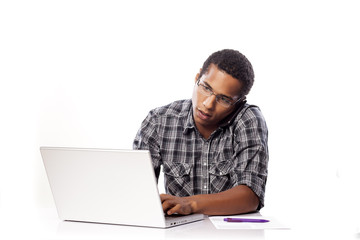 serious young black man writes data from his laptop