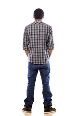 Naklejka premium rear view of young black man with his hands in his pockets
