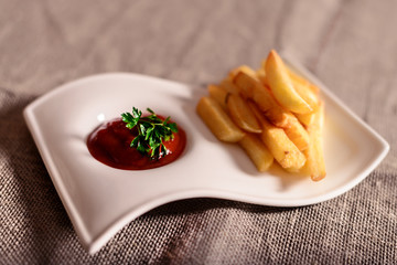 fried French fries with red sauce ketchup with linen background