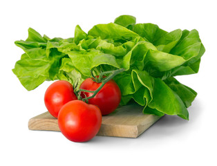 Head of lettuce and three tomatoes isolated on white background